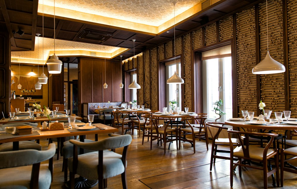 Contemporary restaurant with wooden tables and warm pendant lighting